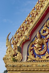 Beautiful architecture of a Thai temple style decorating with golds and metals