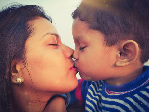 mother and son kissing
