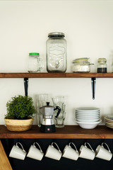 Fototapeta na wymiar Dish on open shelves in kitchen