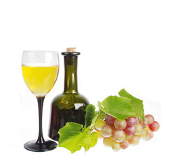 A glass of white wine, bottle and a bunch of grapes. Isolated on white