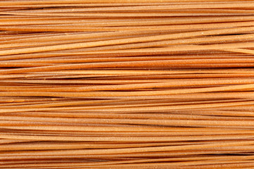 Dry buckwheat noodles texture, shot from the top. Soba background