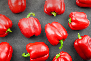 red sweet pepper on dark textile background , top view