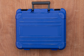 blue tool box on wood background.