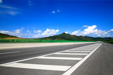 Fototapeta premium Highway, under the background of blue sky and white clouds