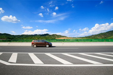 Highway, under the background of blue sky and white clouds