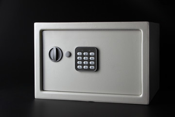 modern light money bank safe on a black background with a coded lock
