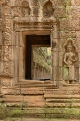 Colonnade seen through stone window with statue