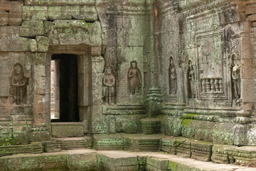 Fototapeta na wymiar Decorated entrance and bas-reliefs in stone temple