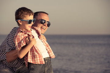 Father and son playing on the beach at the day time.