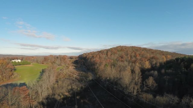 Aerial Reverse Dolly of Overhead Power Lines in Forest Near the Bradley Hubbard Reservoir