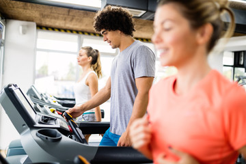 Pretty girl working out in a treadmill at the gym