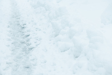 Fototapeta na wymiar Empty footpath in snow
