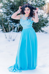 Fototapeta na wymiar Greece woman in blue long romantic dress at snowy day, femininity and grace concept, winter fairytale 