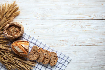 Fototapeta na wymiar Still life with bread, flour and spikelets