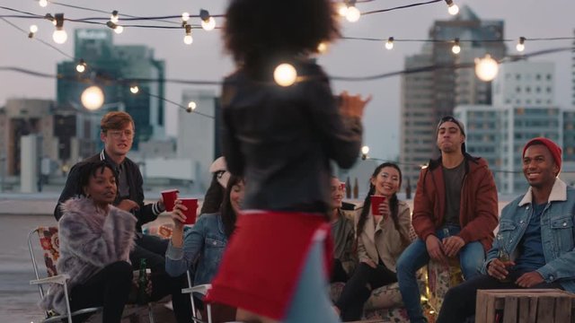 multi ethnic group of friends posing for photo on rooftop party at sunset students enjoying weekend gathering in urban city