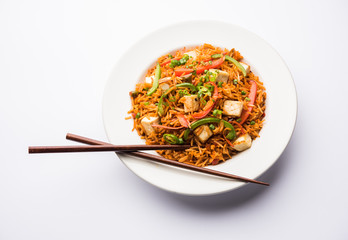 Schezwan paneer fried rice with Szechuan sauce and cottage cheese cubes. served in a bowl or plate or pan. selective focus