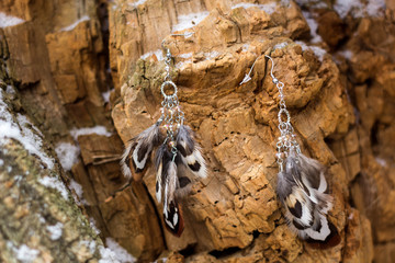 Obraz na płótnie Canvas earrings of Handmade dream catcher with feathers threads and beads rope hanging