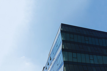 Fototapeta na wymiar Modern glass business center building with blue sky on the background. Copy space.