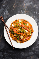 Schezwan paneer fried rice with Szechuan sauce and cottage cheese cubes. served in a bowl or plate or pan. selective focus