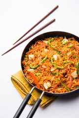 Schezwan paneer fried rice with Szechuan sauce and cottage cheese cubes. served in a bowl or plate or pan. selective focus