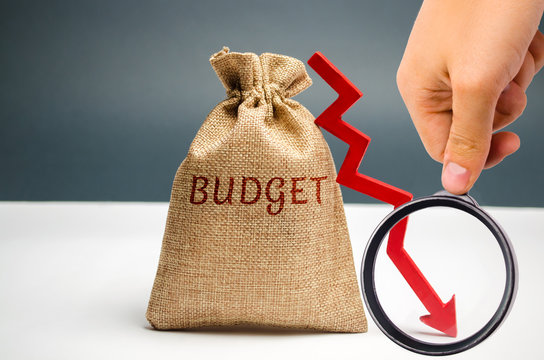 Money bag with word Budget and down arrow. Unsuccessful business and poverty. Profit decline. Loss of investment. Low wages and savings. Economic crisis. fall of the financial market