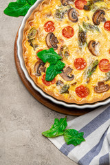 Baked homemade quiche pie in ceramic baking form