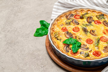Baked homemade quiche pie in ceramic baking form