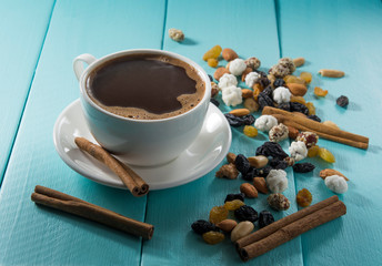 cup of coffee and cinnamonon wooden table