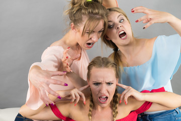 Woman being bullied by two females