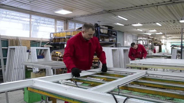 Install rubber sealant in plastic windows and doors. Manual worker assembling PVC doors and windows. Rubber gasket in plastic windows. Rubber Insulation for windows and doors.