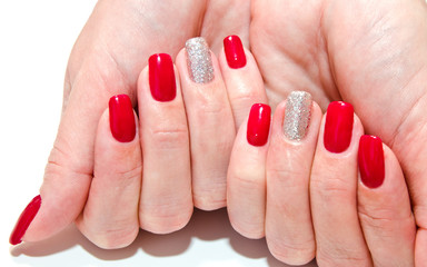 Woman's nails with beautiful red manicure fashion design with gems isolated