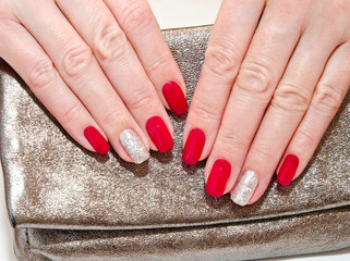 Woman's nails with beautiful red manicure fashion design