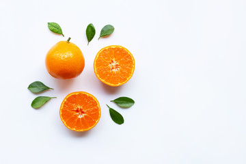 Orange fruits and green leaves on a white background.