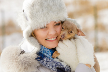 Woman playing with dog during winter