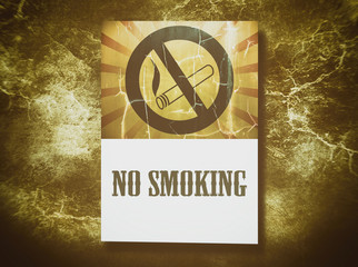 No smoking sign on grunge wall background.