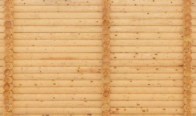 the texture of the log wall of a wooden house under construction
