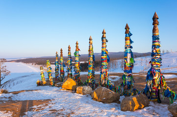 Wooden ritual pillars with colorful ribbons