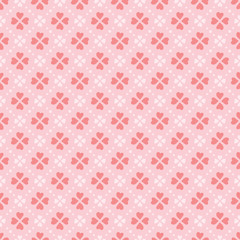 Vector heart shape petals flowers seamless pattern background in coral colors. Appropriate for fabric, gift wrap, cards for a Valentine Day, wedding, and other similar projects.