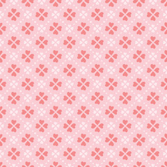Vector heart shape petals flowers seamless pattern background in coral colors. Appropriate for fabric, gift wrap, cards for a Valentine Day, wedding, and other similar projects.