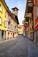 Fototapeta na wymiar Street view and town hall tower of Palazzo Civico in Bellinzona, Ticino, Switzerland