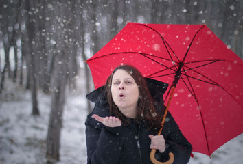 Woman With A Red Umbrella Enjoying The Snow