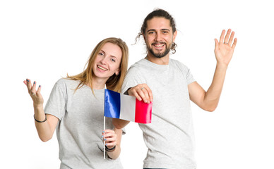 Fototapeta premium Hello from France. Happy couple in gray t-shirts with french flag isolated on white background. Young people, man and woman.