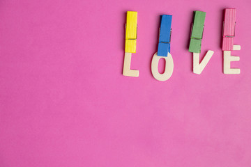 word LOVE in red hearts on pink background, Love icon, valentine's day, relationships concept with copy space