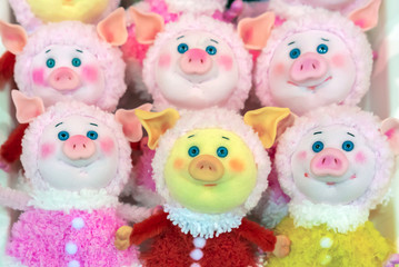 Soft toys piggies with expressive blue eyes.