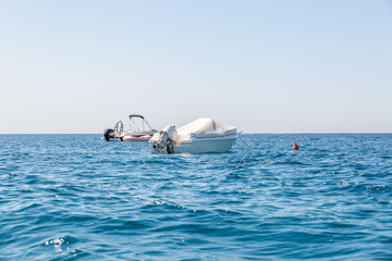 Naklejka premium Two yachts moored in the sea near a shore