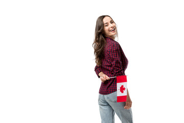 attractive smiling woman holding canadian flag isolated on white
