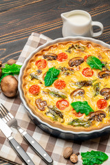 Baked homemade quiche pie in ceramic baking form
