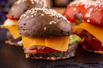 Burger with a turkey, tomatoes and capers, red onions, cheese and cowberry sauce
