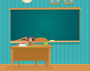 Interior of classroom with desk and blackboard.