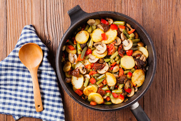 Fried pan vegetables, with mushrooms and dried tomatoes. Seasoned with a mix of herbs.